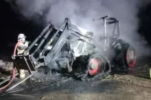 Strażacy gaszą pożar ciągnika rolniczego